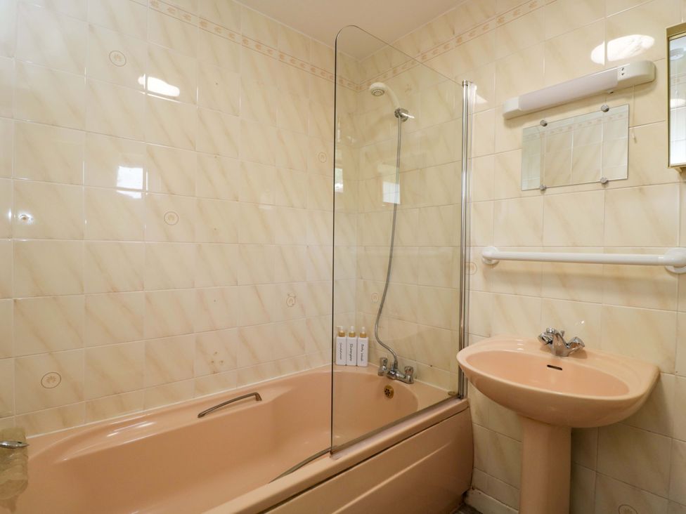 A bathroom with a bathtub and sink at The Garden Studio in Bremhill near Calne