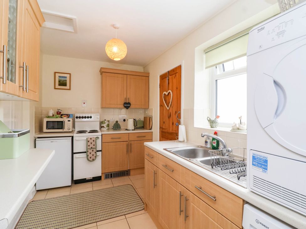 A kitchen with appliances and cabinets at 96 Chapel Lane Butleigh