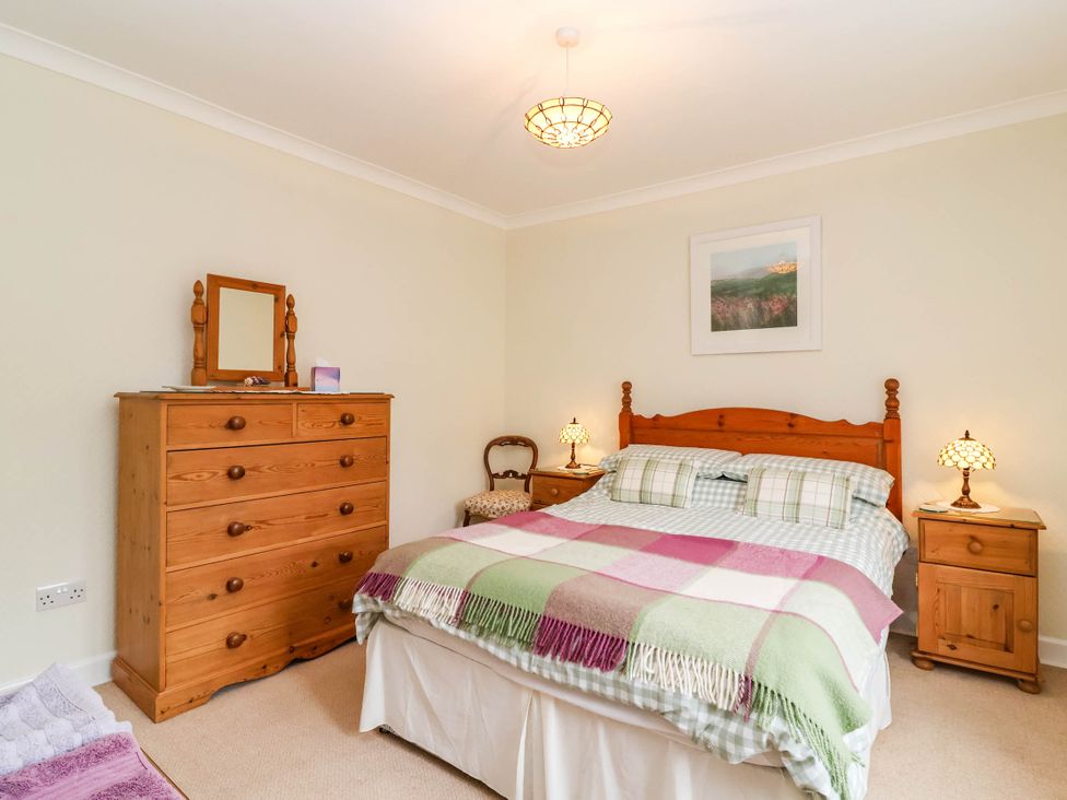 A bedroom with a bed and dressing table at 96 Chapel Lane Butleigh