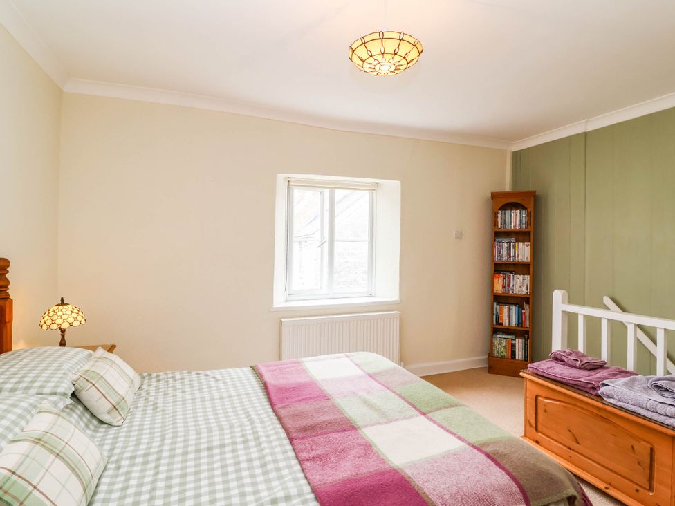 A bedroom with a bed and bookcase at 96 Chapel Lane Butleigh
