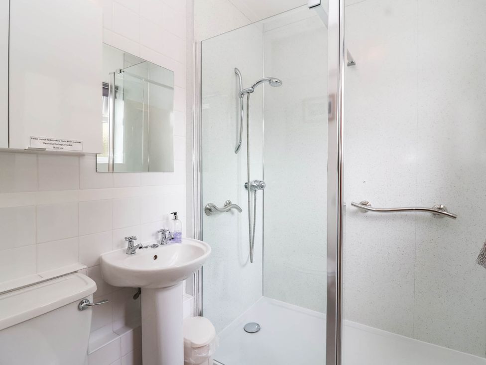 A bathroom with a shower, toilet, and sink at 96 Chapel Lane Butleigh