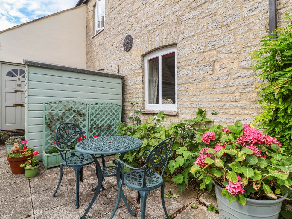 A patio area with a table and chairs at 96 Chapel Lane Butleigh