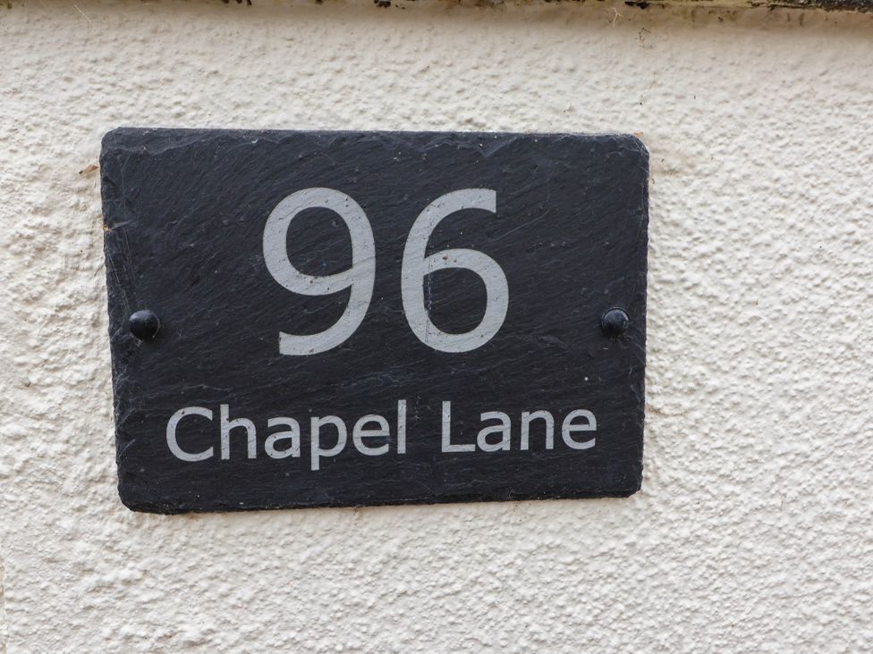 A sign with the house number 96 and street name Chapel Lane at 96 Chapel Lane Butleigh