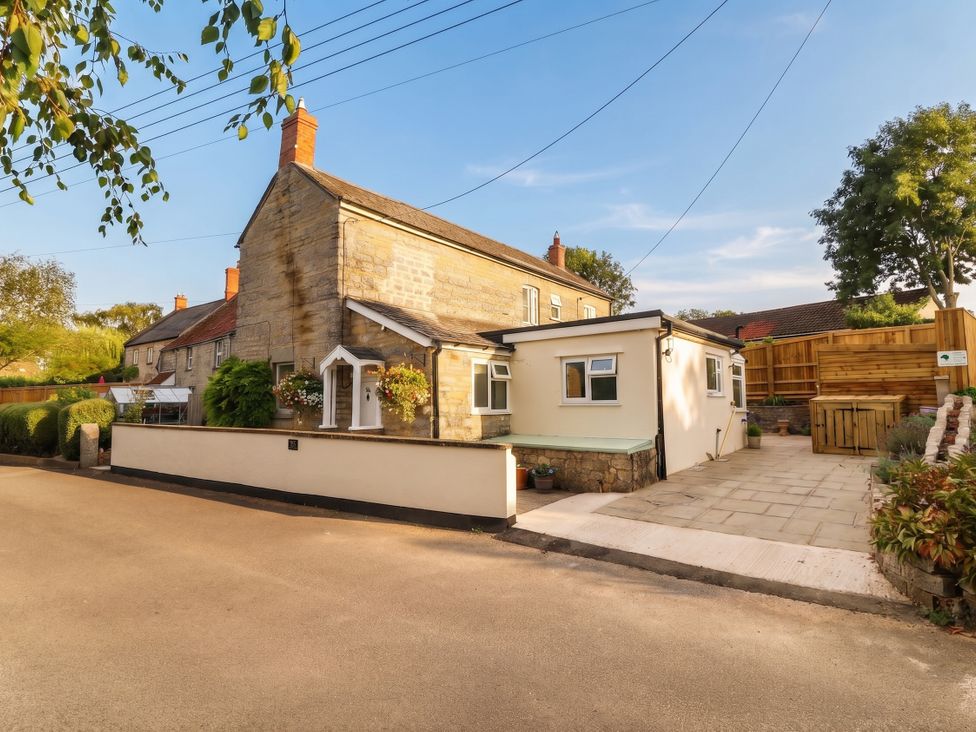 A house with windows and plants at 96 Chapel Lane Butleigh