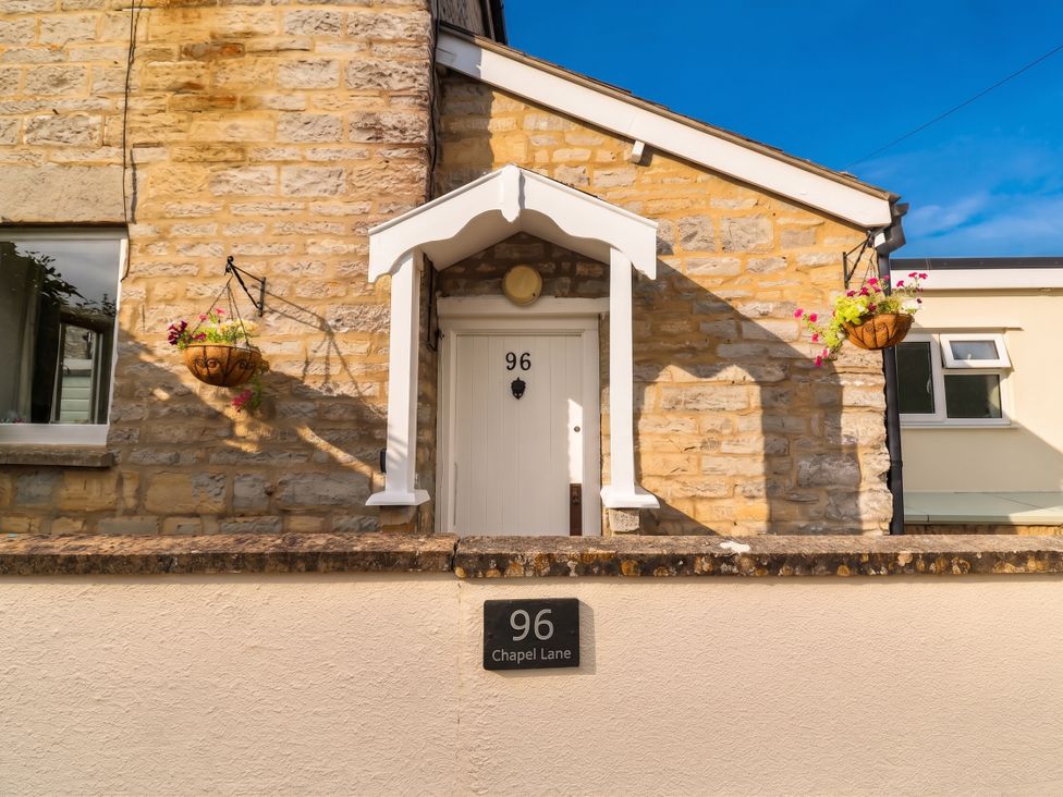 The entrance of a house with a door and window at 96 Chapel Lane Butleigh