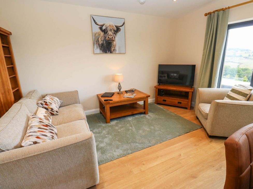 A living room with a couch, chair, and coffee table at The Stables in Stainland