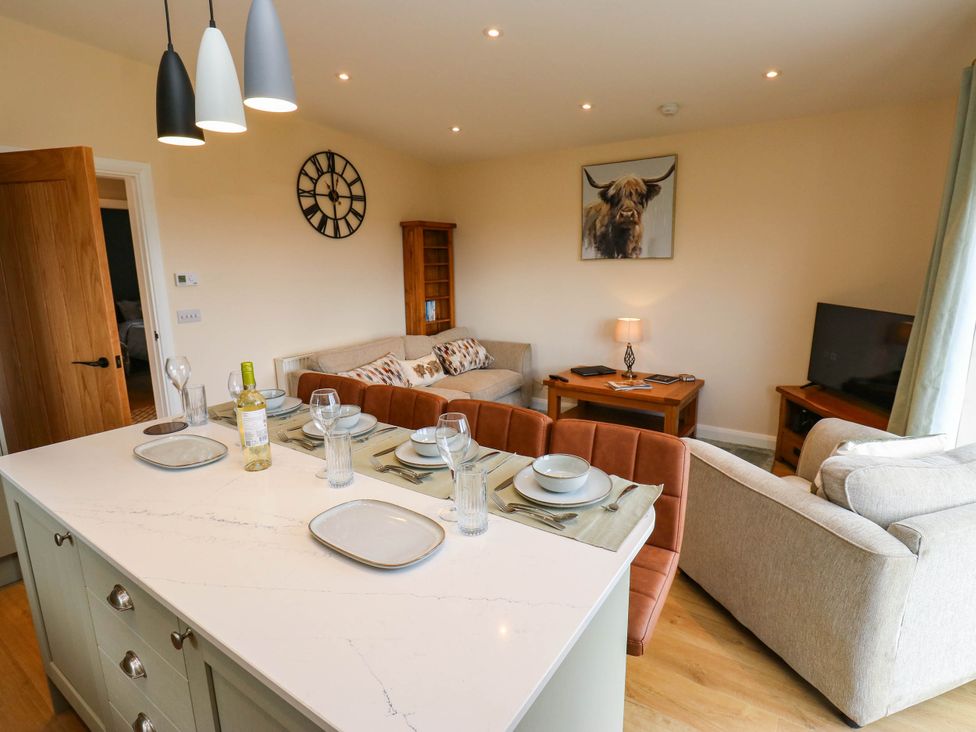 A kitchen and living room with seating and dining setup at The Stables in Stainland