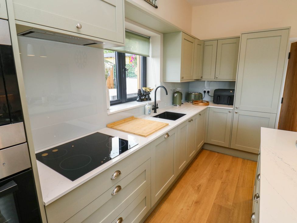 A kitchen with a sink and cooking surface at The Stables in Stainland