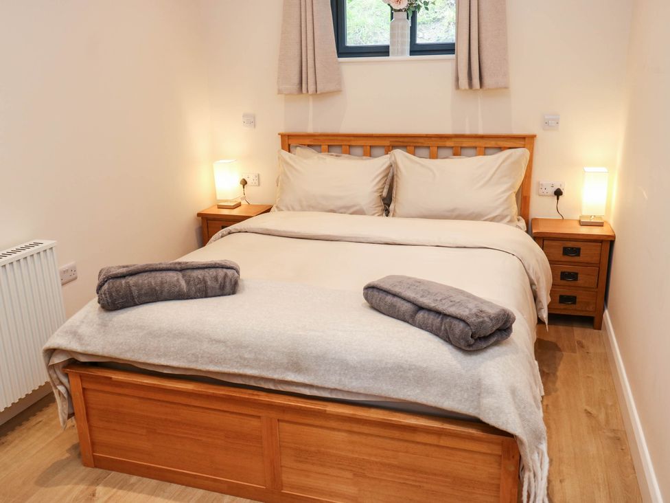 A bedroom with a bed and bedside table at The Stables in Stainland