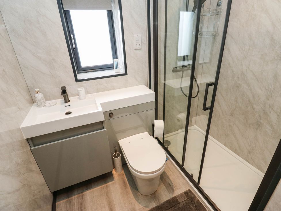 A bathroom with a sink, toilet and shower at The Stables in Stainland