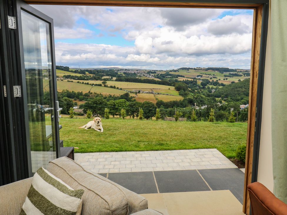 A view of a field and dog from a room at The Stables in Stainland