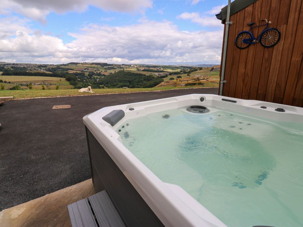 A hot tub with a view of countryside at The Stables in Stainland