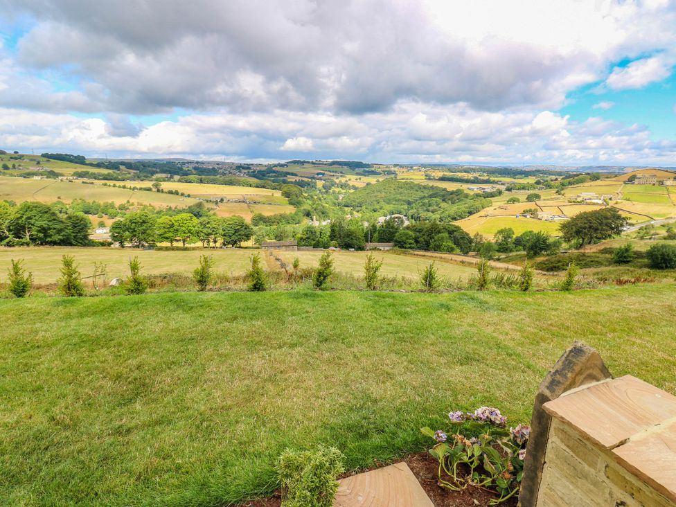 A view of hills and farmland with grass and plants at The Stables in Stainland
