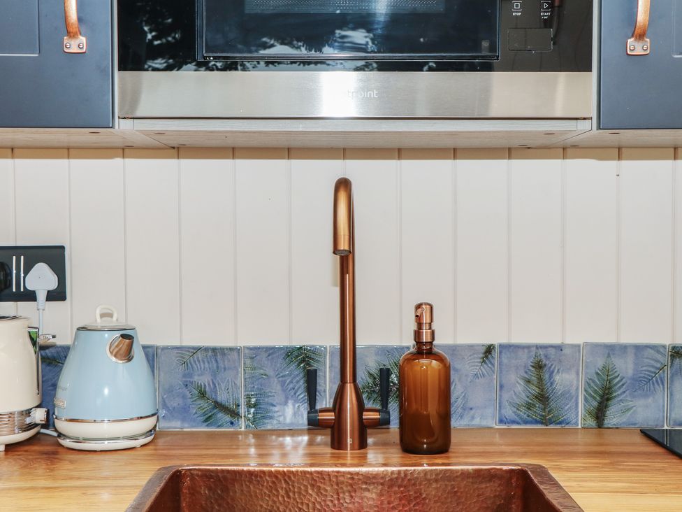 A kitchen with a sink and kettle at Ridden Brake shepherds hut Yelverton