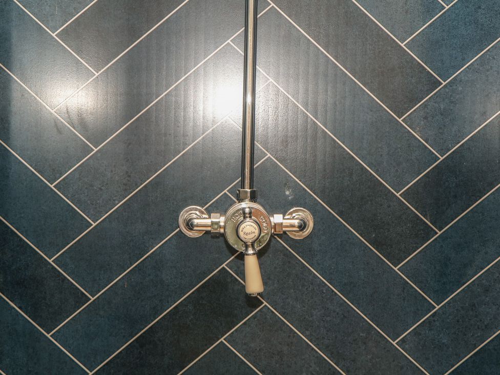 A shower valve on a tiled wall at Ridden Brake shepherds hut in Yelverton