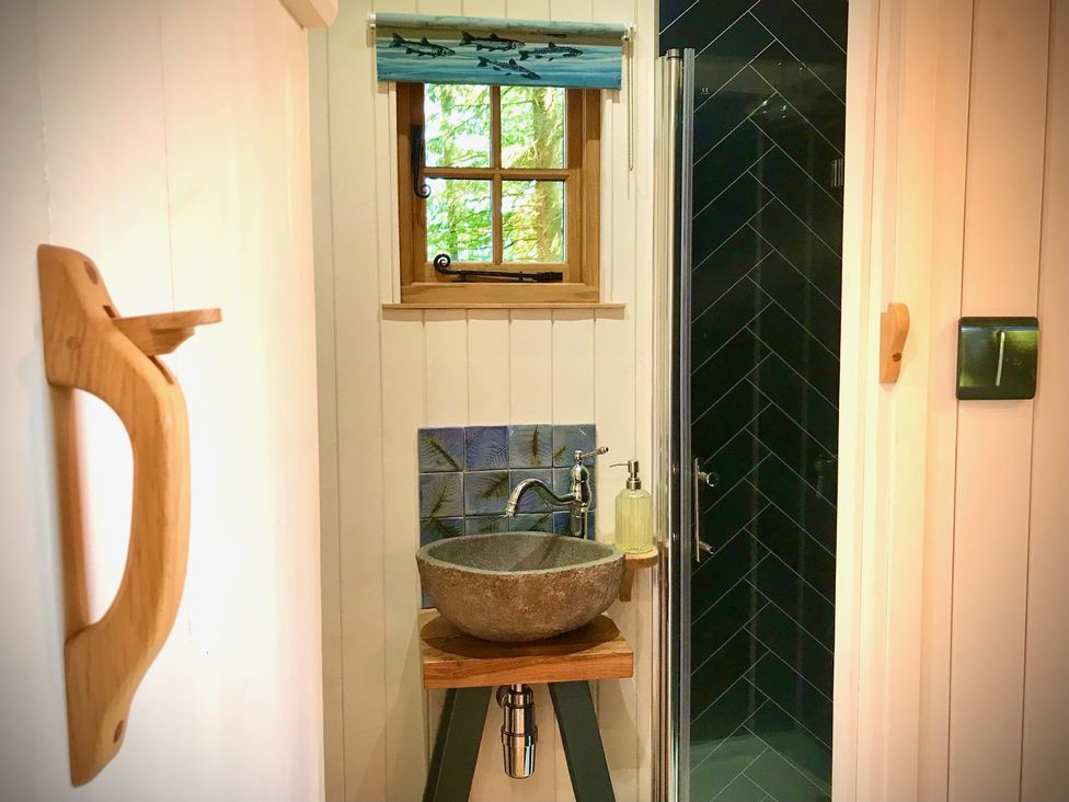 A bathroom with a sink and shower at Goldcrest Postbridge