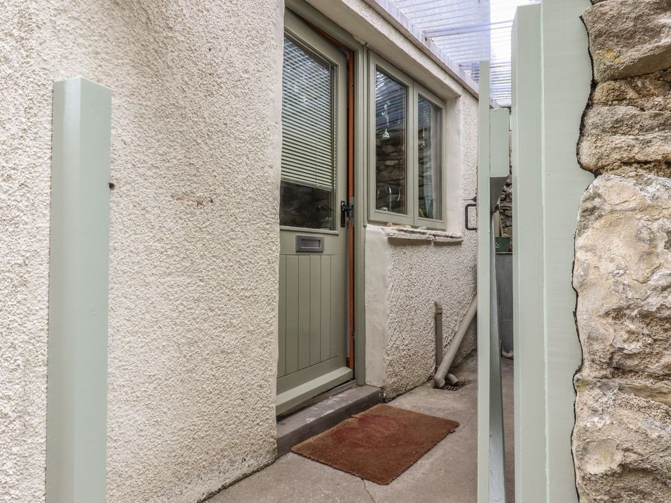 An entrance with a door and welcome mat at The Cottage in Giggleswick