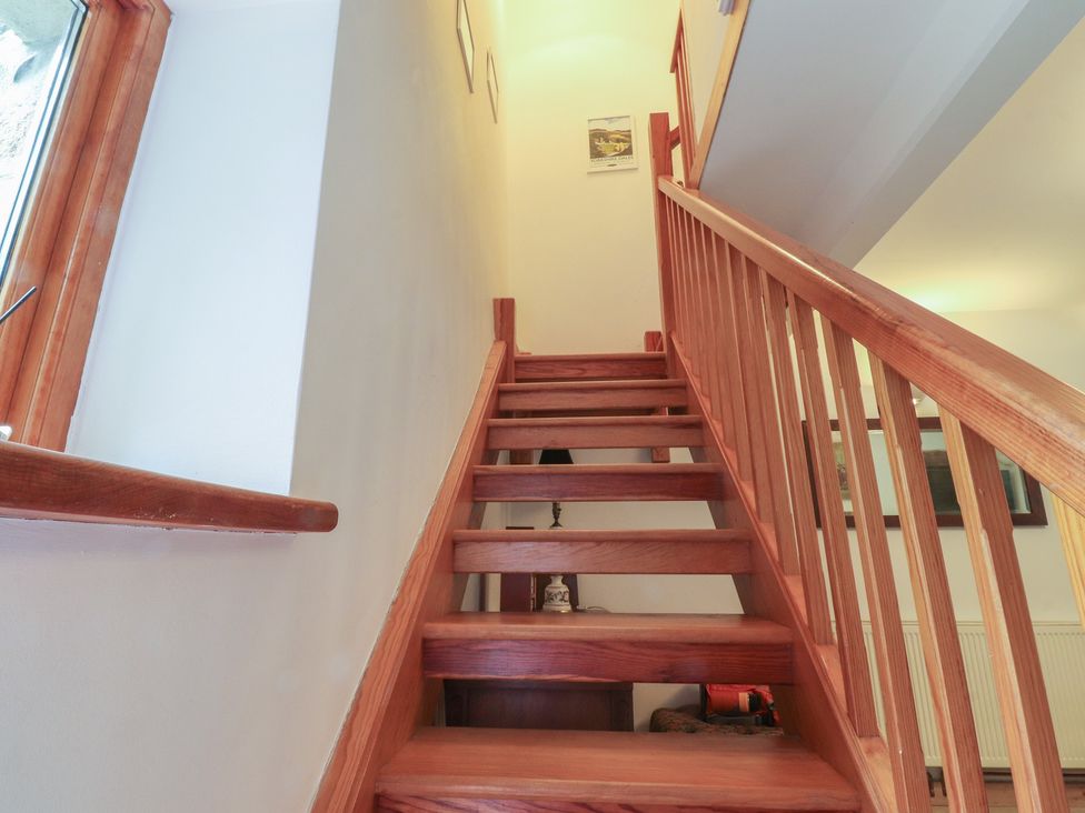 A staircase with wooden steps and a handrail at The Cottage in Giggleswick