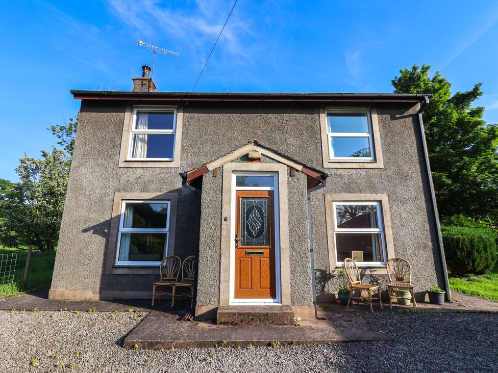 A house with a front door and chairs at Robin Hood Farmhouse in Keswick