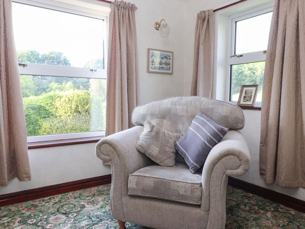 A snug with an armchair and window at Robin Hood Farmhouse in Keswick