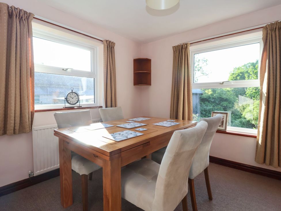 A dining room with a table and chairs at Robin Hood Farmhouse in Keswick