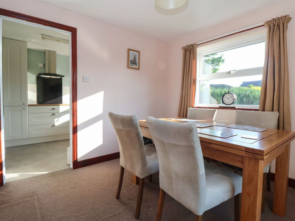 A dining room with a table and chairs at Robin Hood Farmhouse in Keswick