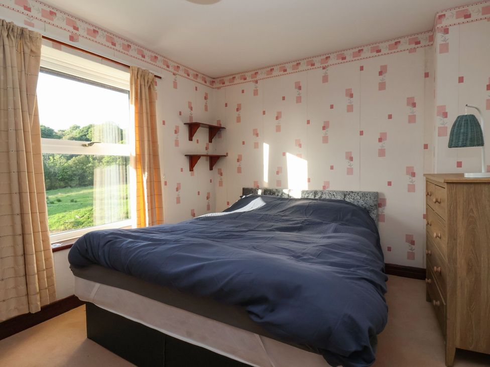A bedroom with a bed and a window at Robin Hood Farmhouse in Keswick