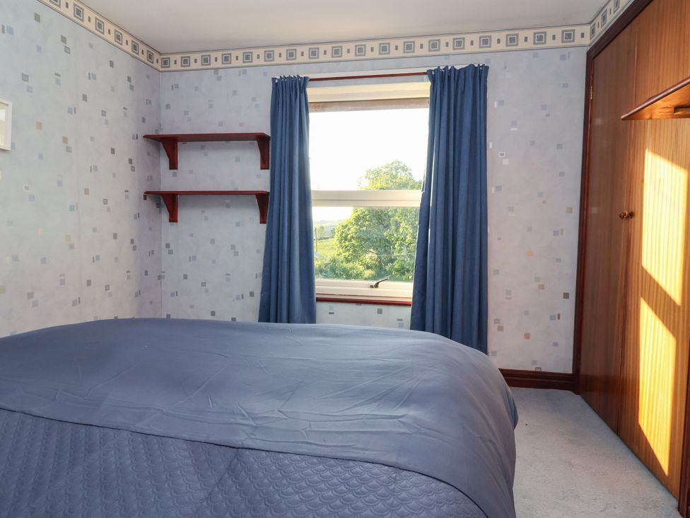 A bedroom featuring a bed and window at Robin Hood Farmhouse in Keswick