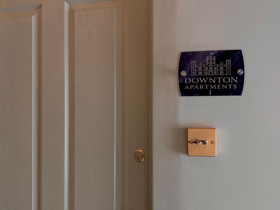 A door with a nameplate at Downton Apartments I in Alnwick