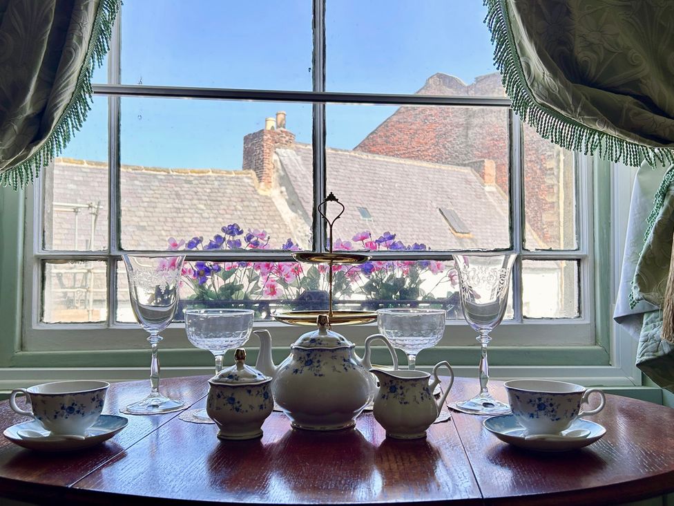 A kitchen with tea set and flowers viewed from window at Downton I Alnwick