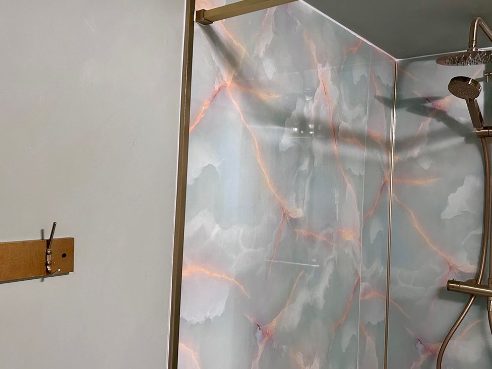 A shower with a decorative wall and a hook at Downton I in Alnwick