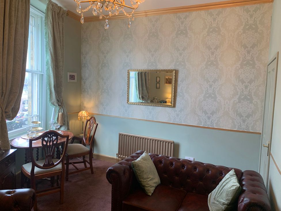 A living room with a sofa and dining table at Downton I in Alnwick