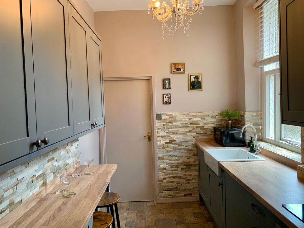 A kitchen with cabinets, sink, and countertop at Downton I in Alnwick