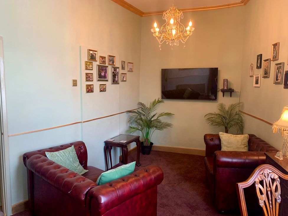 A living room with a sofa and television at Downton I Alnwick