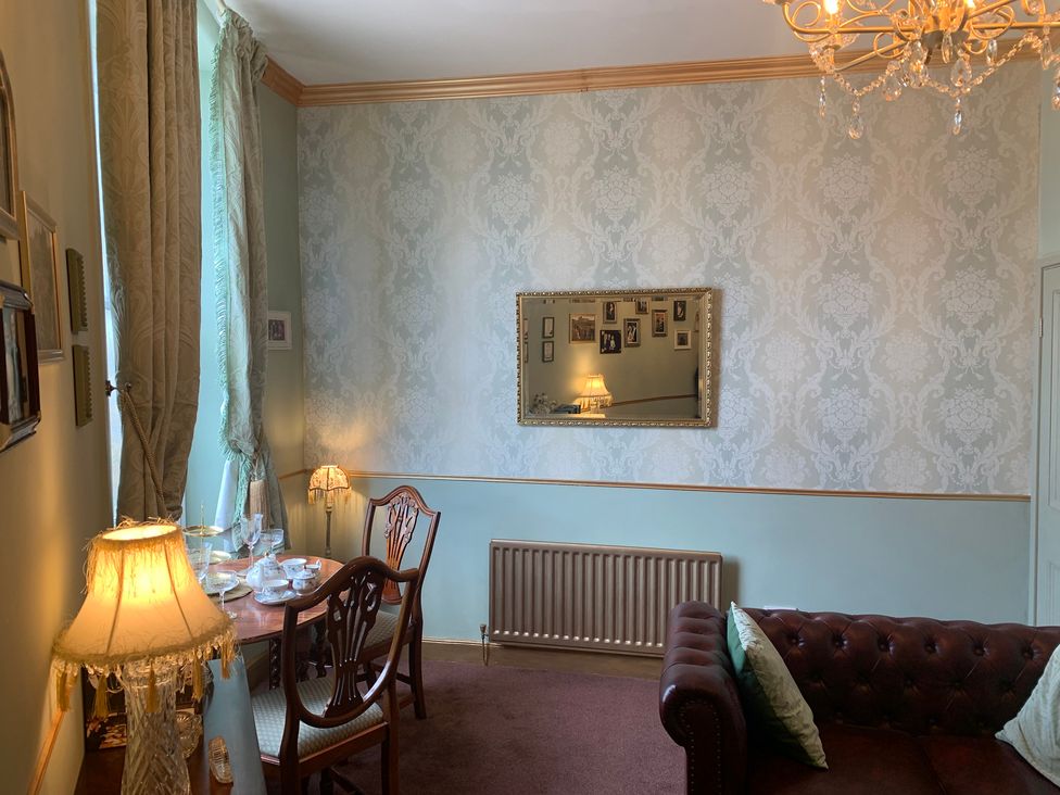 A sitting room with a table and sofa at Downton I in Alnwick