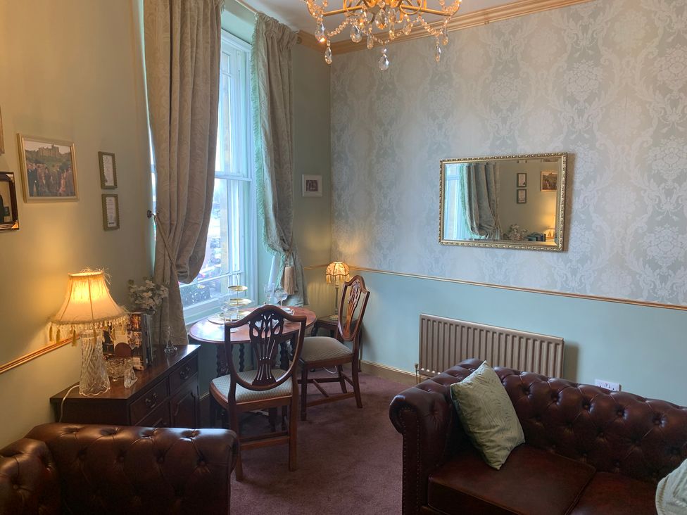 A living room with a table and chairs at Downton I Alnwick