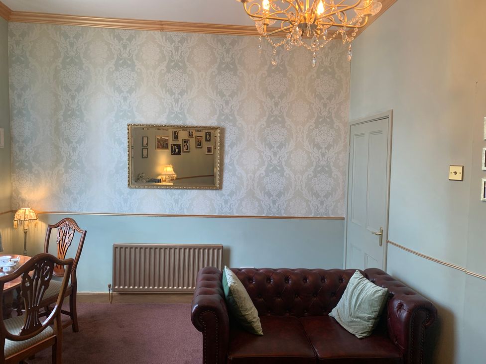 A living room with a sofa and table at Downton I in Alnwick
