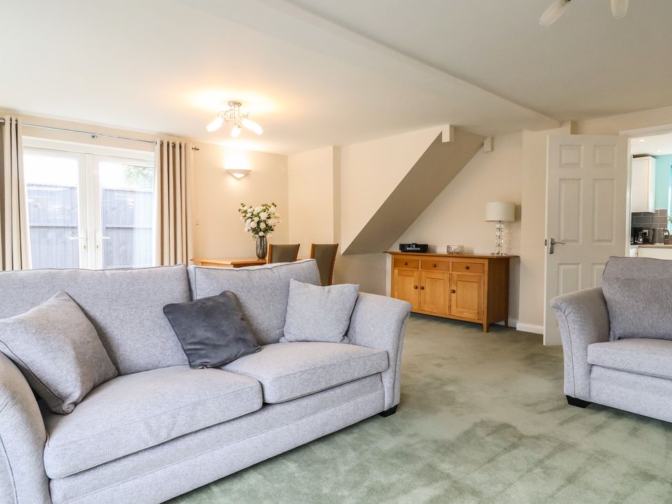 A living room with sofas and a dining table at Frome View in Wool