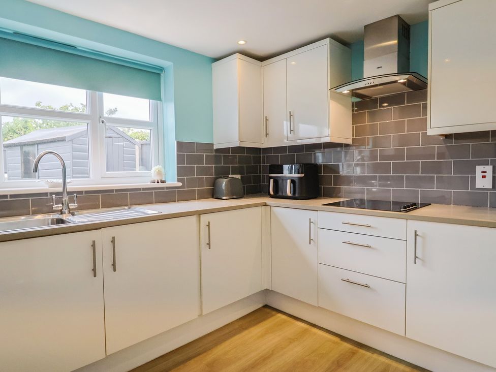 A kitchen with cabinets and appliances at Frome View in Wool