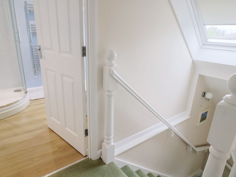 A bathroom with a shower and stairs at Frome View Wool