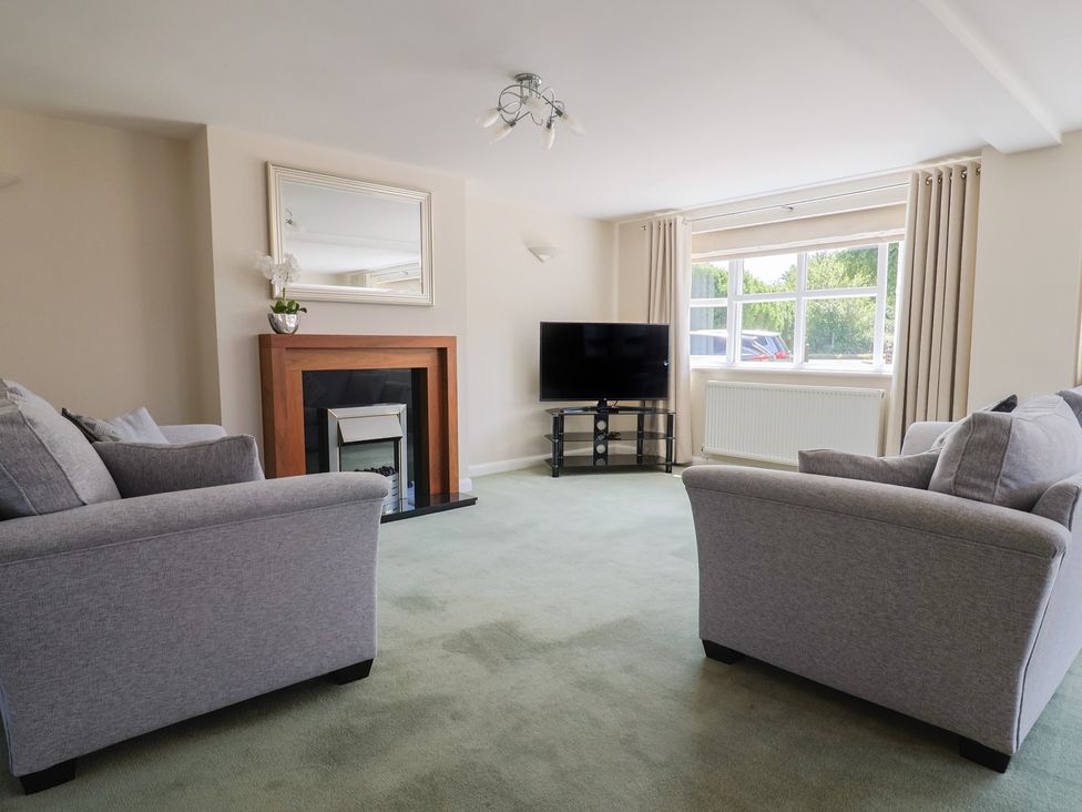 A living room with sofas and a television at Frome View in Wool
