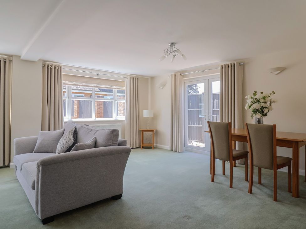 A living room with a sofa, table, and chairs at Frome View in Wool