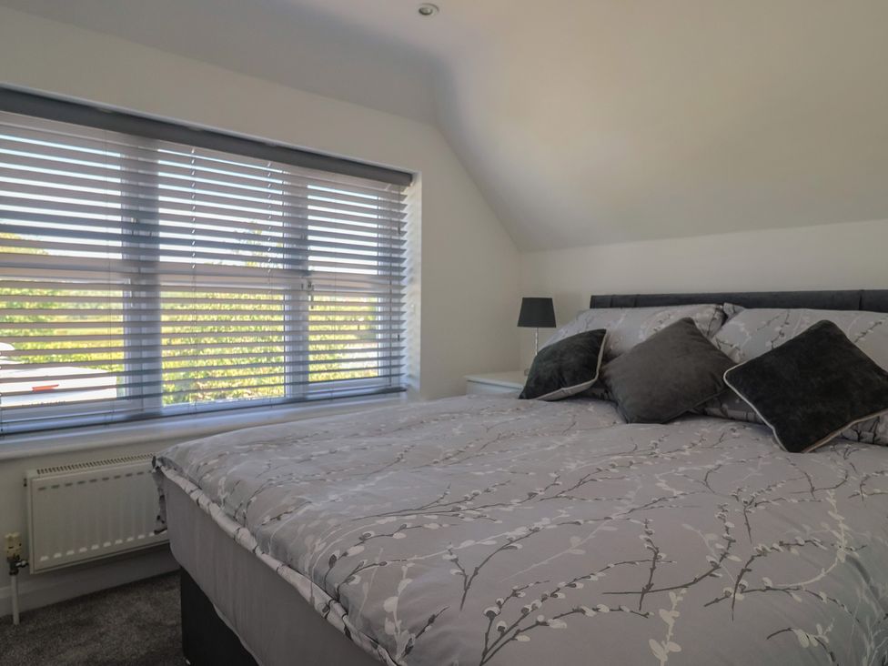 A bedroom with a bed and window at Frome View in Wool