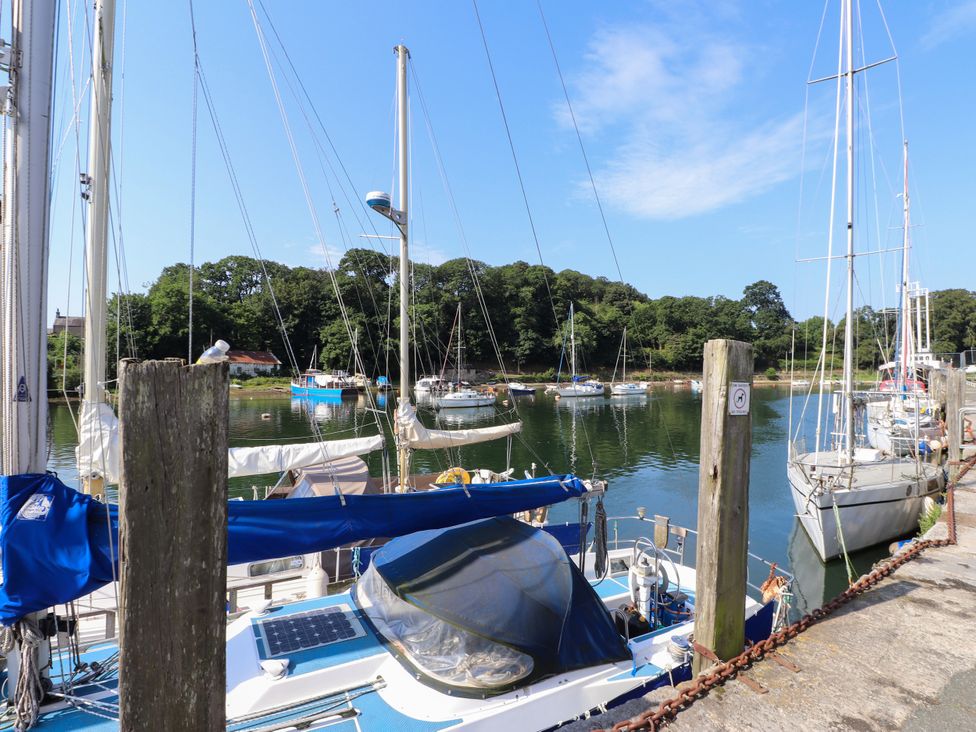 A marina with sailboats and a dock at Scoops’ Nook Caernarfon