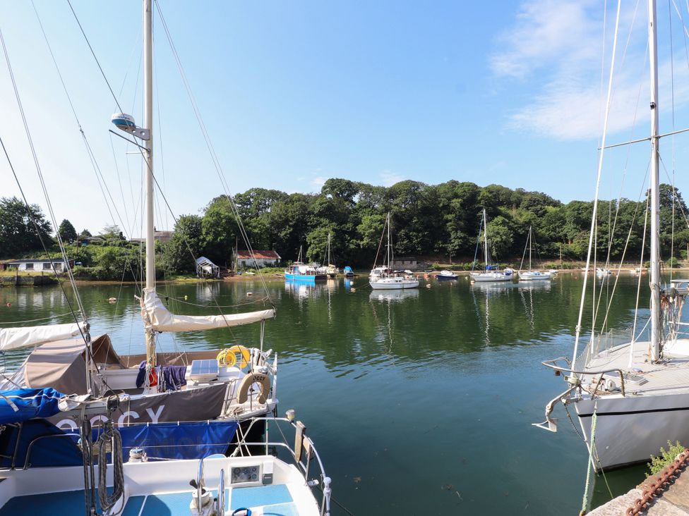 A view of boats on water with trees in the background at Scoops’ Nook, Caernarfon