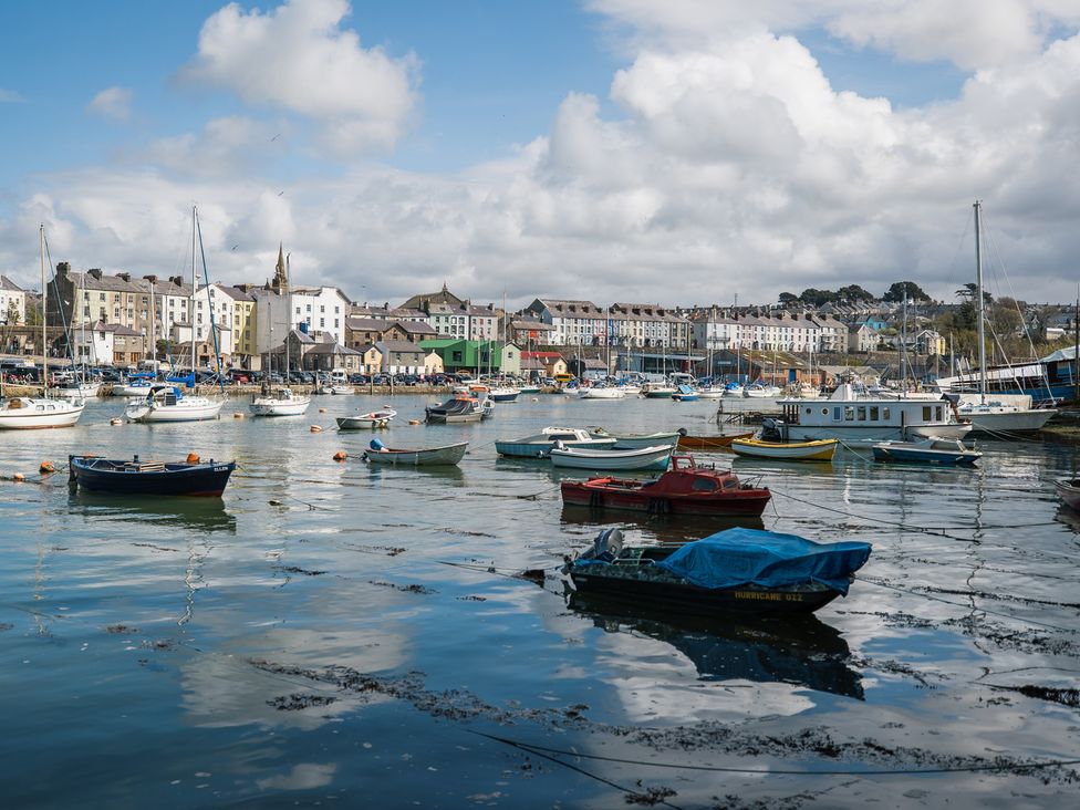 A harbor with boats and buildings at Scoops’ Nook in Caernarfon