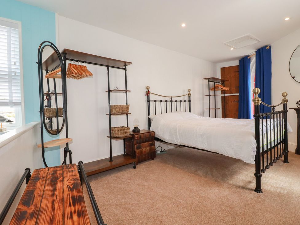 A bedroom with a bed and storage furniture at 31 Tregoney Hill in Mevagissey