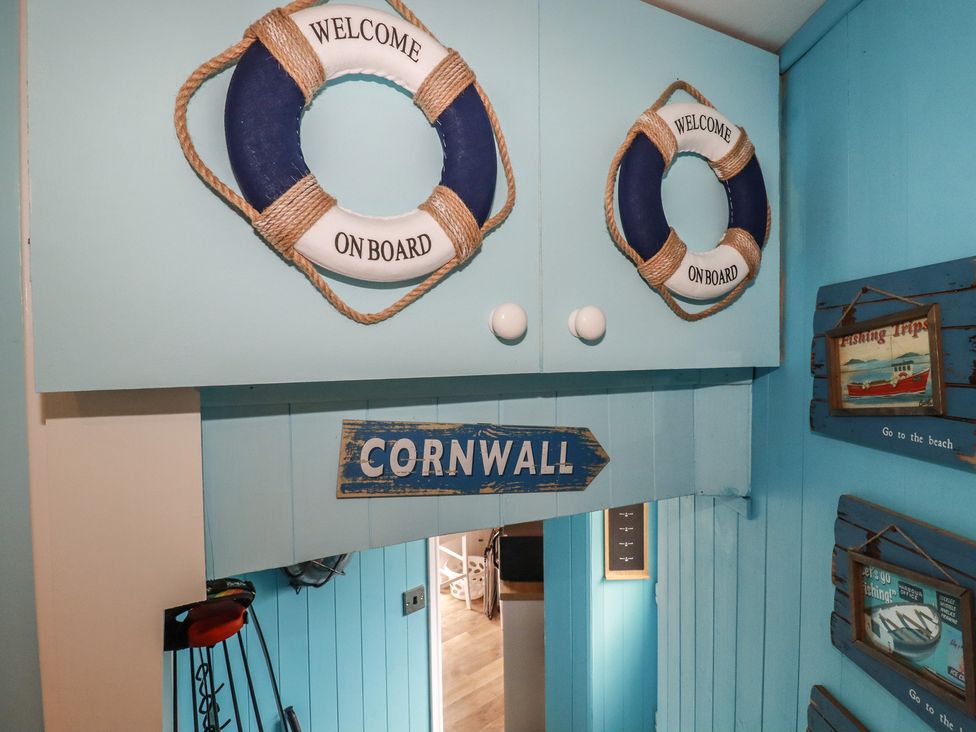An entrance hall featuring life rings and a sign at 31 Tregoney Hill Mevagissey