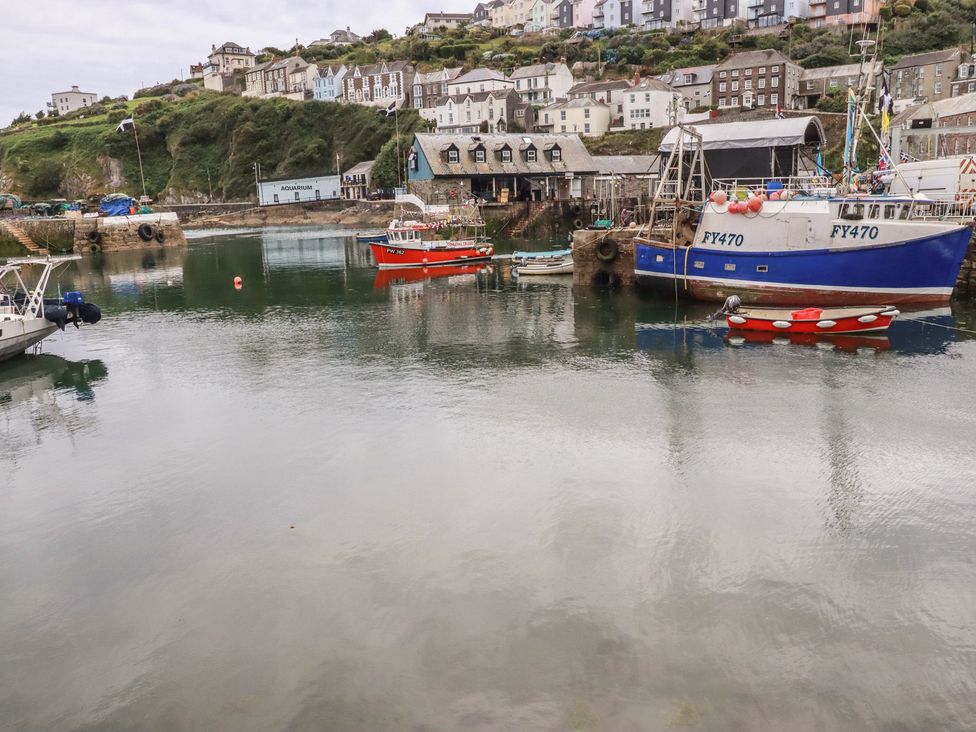 A harbor with boats and buildings at 31 Tregoney Hill in Mevagissey