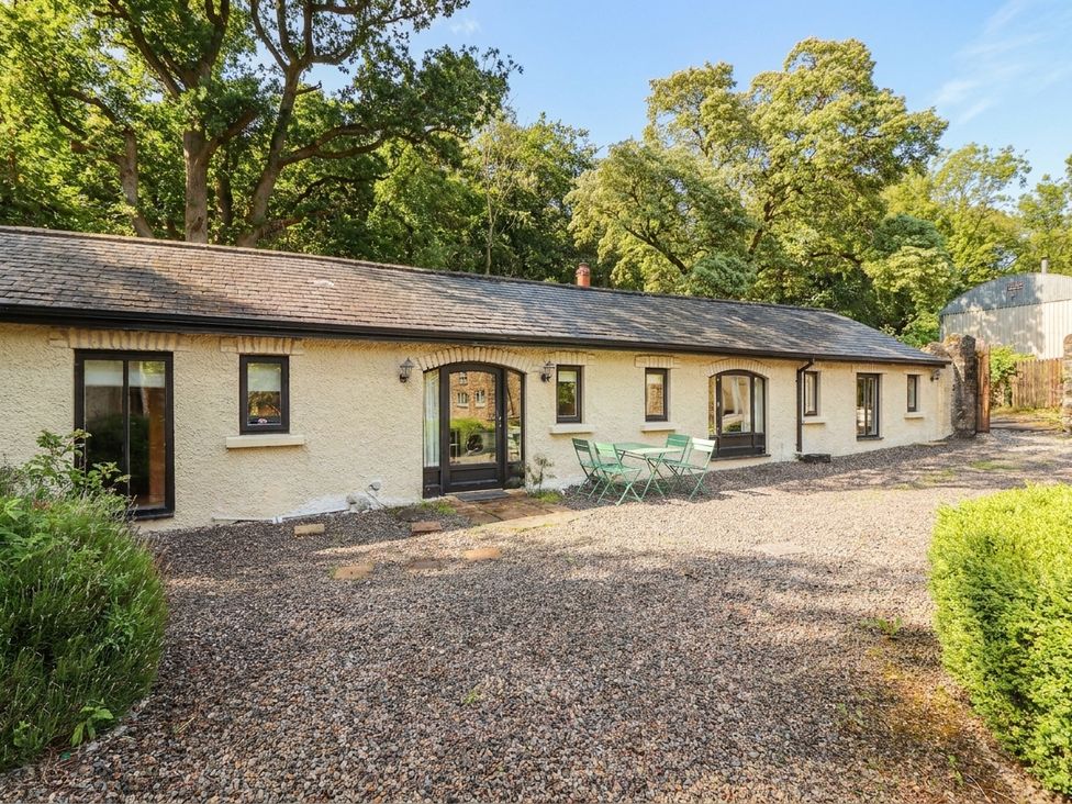 An outdoor view of a house with windows and a door at The Coach House Cottage Ballycommon